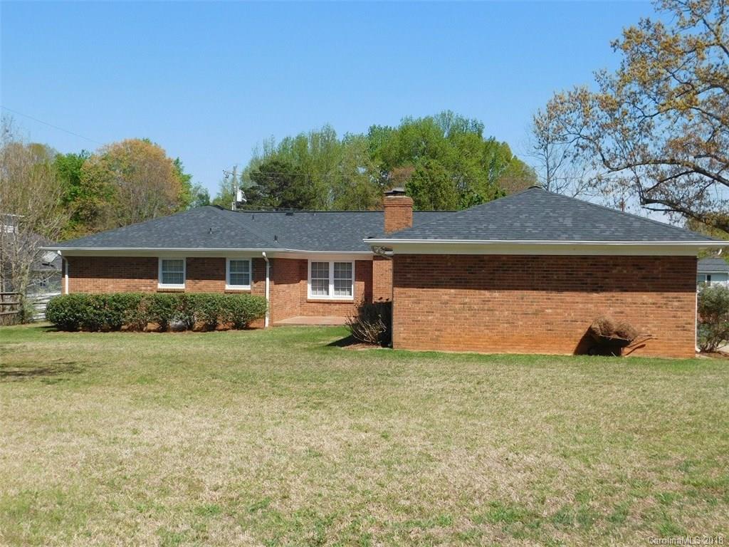 6311 Lake Forest Road East Charlotte, NC 28227 - Photo 29 of 31 a view of a house with a yard and a garage