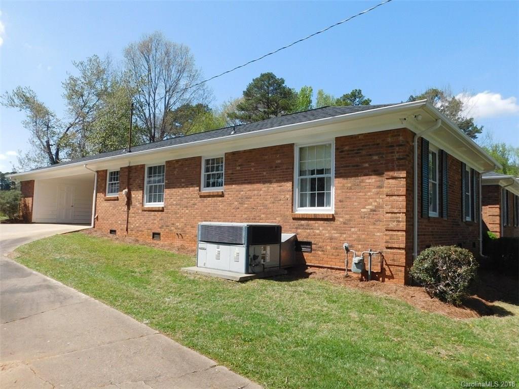 6311 Lake Forest Road East Charlotte, NC 28227 - Photo 30 of 31 a front view of a house with a garden