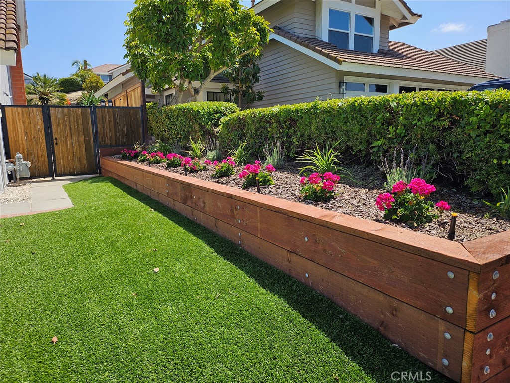 26082 Rio Grande Avenue Laguna Hills, CA 92653 - Photo 12 of 29 a view of garden with flowers and wooden fence
