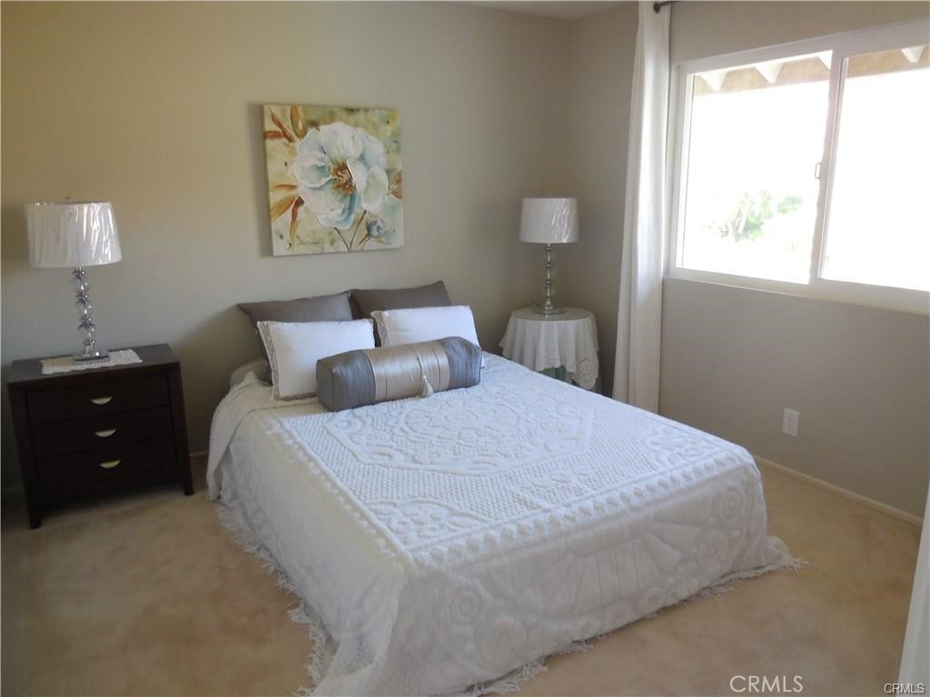 26082 Rio Grande Avenue Laguna Hills, CA 92653 - Photo 17 of 29 a bedroom with a bed and a window