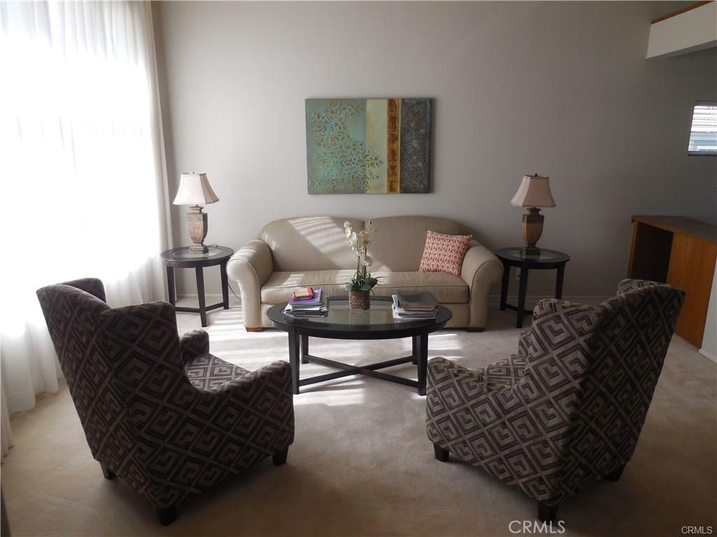 26082 Rio Grande Avenue Laguna Hills, CA 92653 - Photo 20 of 29 a living room with furniture and a lamp