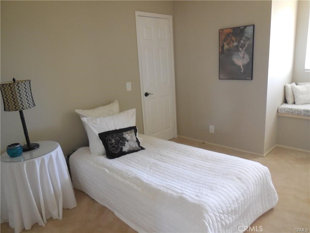 26082 Rio Grande Avenue Laguna Hills, CA 92653 - Photo 22 of 29 a bedroom with a bed and a lamp