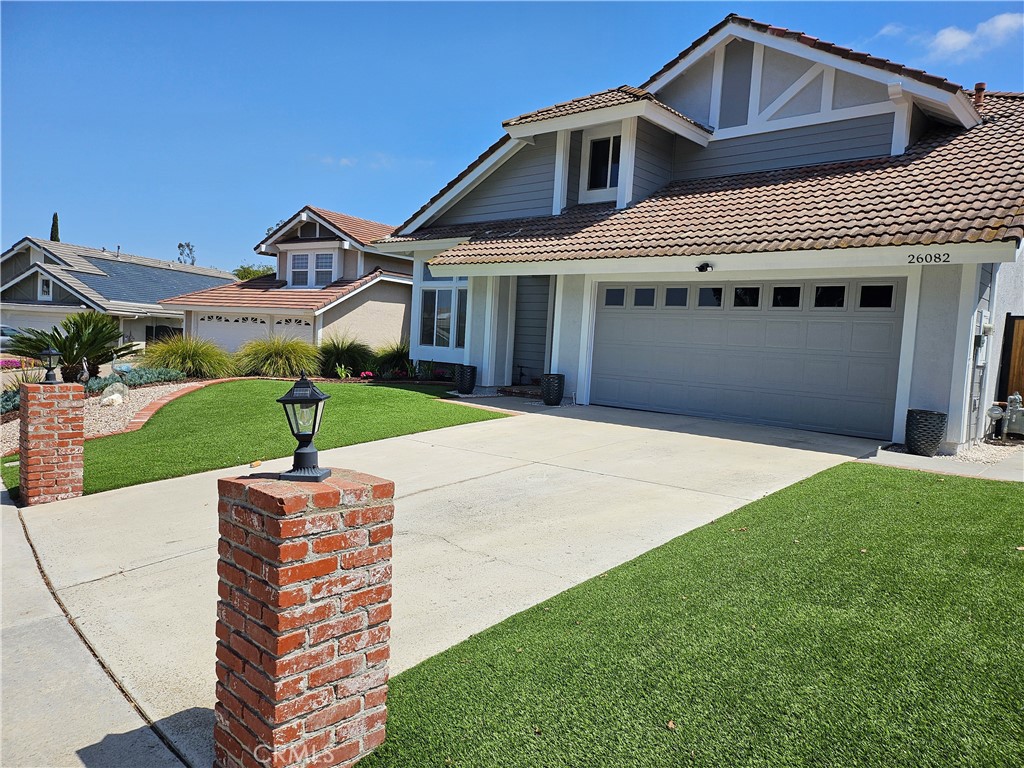 26082 Rio Grande Avenue Laguna Hills, CA 92653 - Photo 3 of 29 a front view of a house with a garden and yard