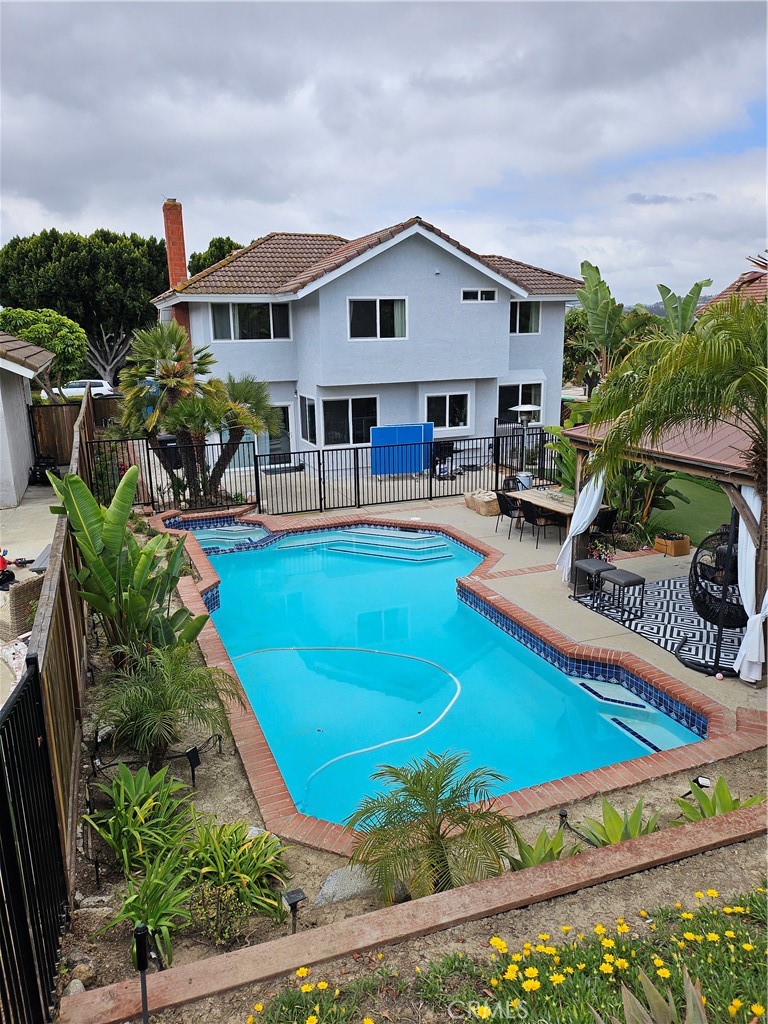 26082 Rio Grande Avenue Laguna Hills, CA 92653 - Photo 5 of 29 a view of a house with pool and chairs