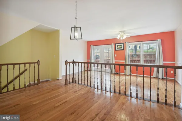 a view of a room with wooden floor and windows