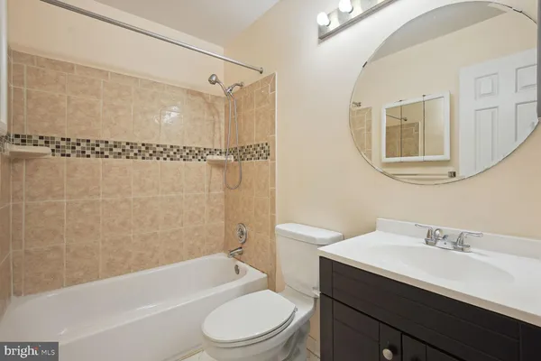 a bathroom with a sink a toilet and a bathtub