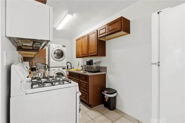 a view of a storage and utility room with sink washer and dryer