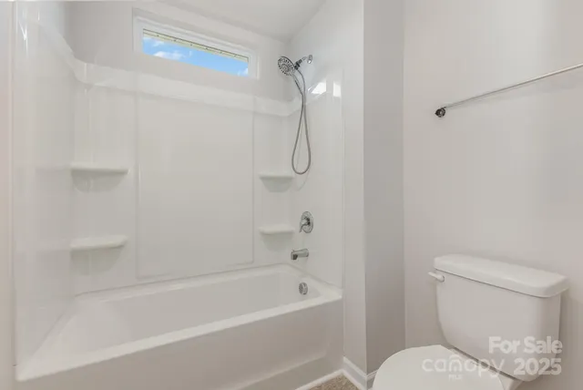 a bathroom with a toilet and a bathtub