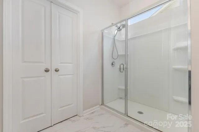 a bathroom with a glass shower door