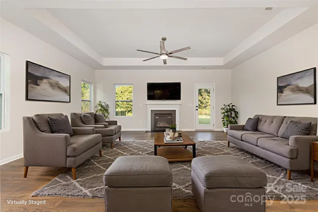 a living room with furniture a fireplace and a flat screen tv