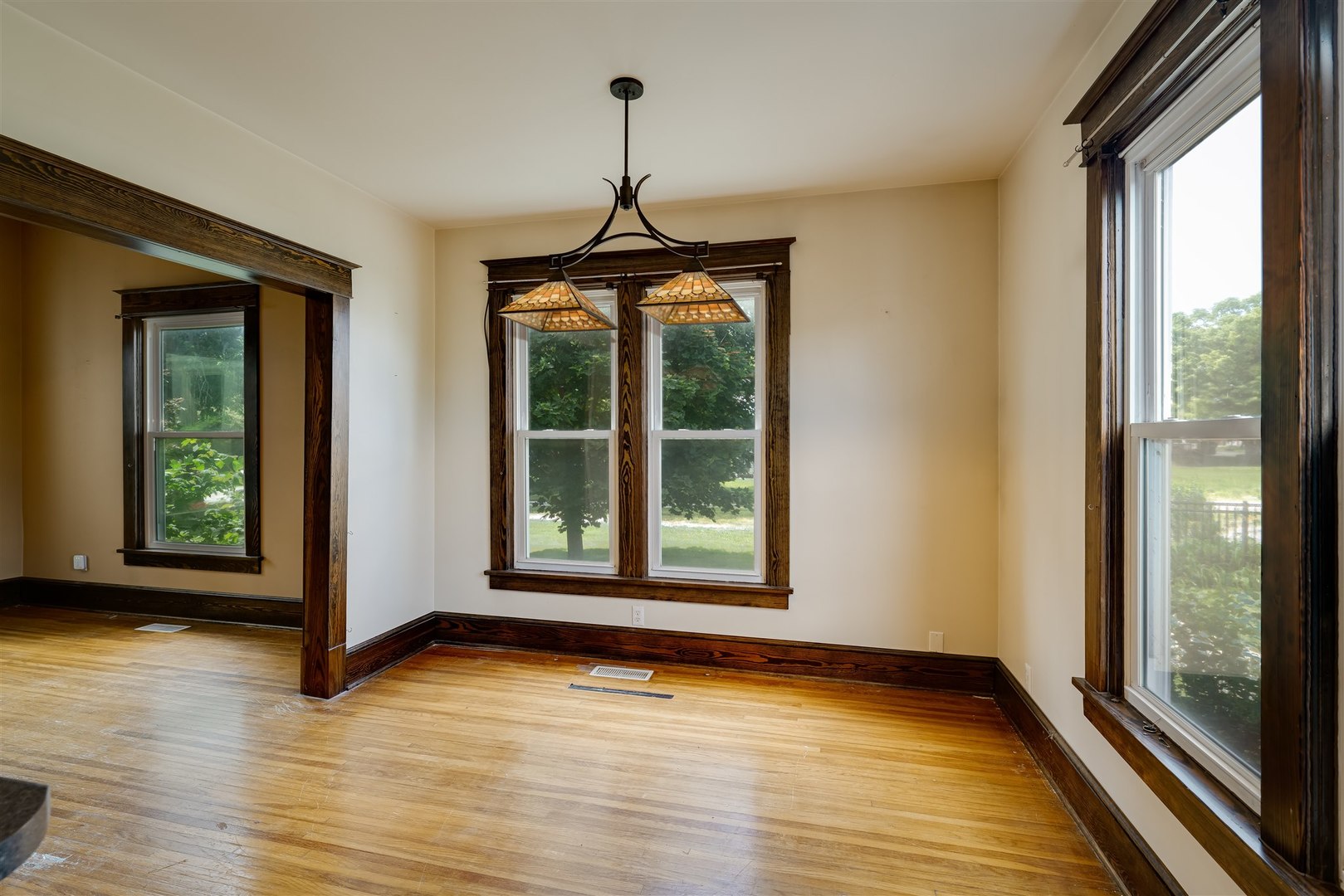 301 West Cooper Street Colfax, IL 61728 - Photo 14 of 69 a view of an empty room with wooden floor and a window