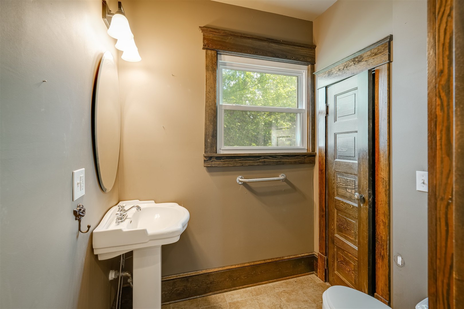 301 West Cooper Street Colfax, IL 61728 - Photo 19 of 69 a bathroom with a sink a toilet and a mirror