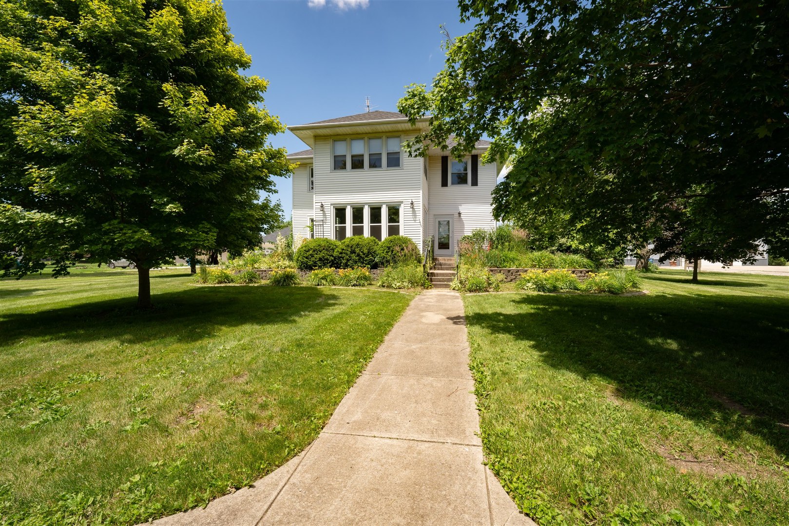 301 West Cooper Street Colfax, IL 61728 - Photo 2 of 69 a view of a garden with plants