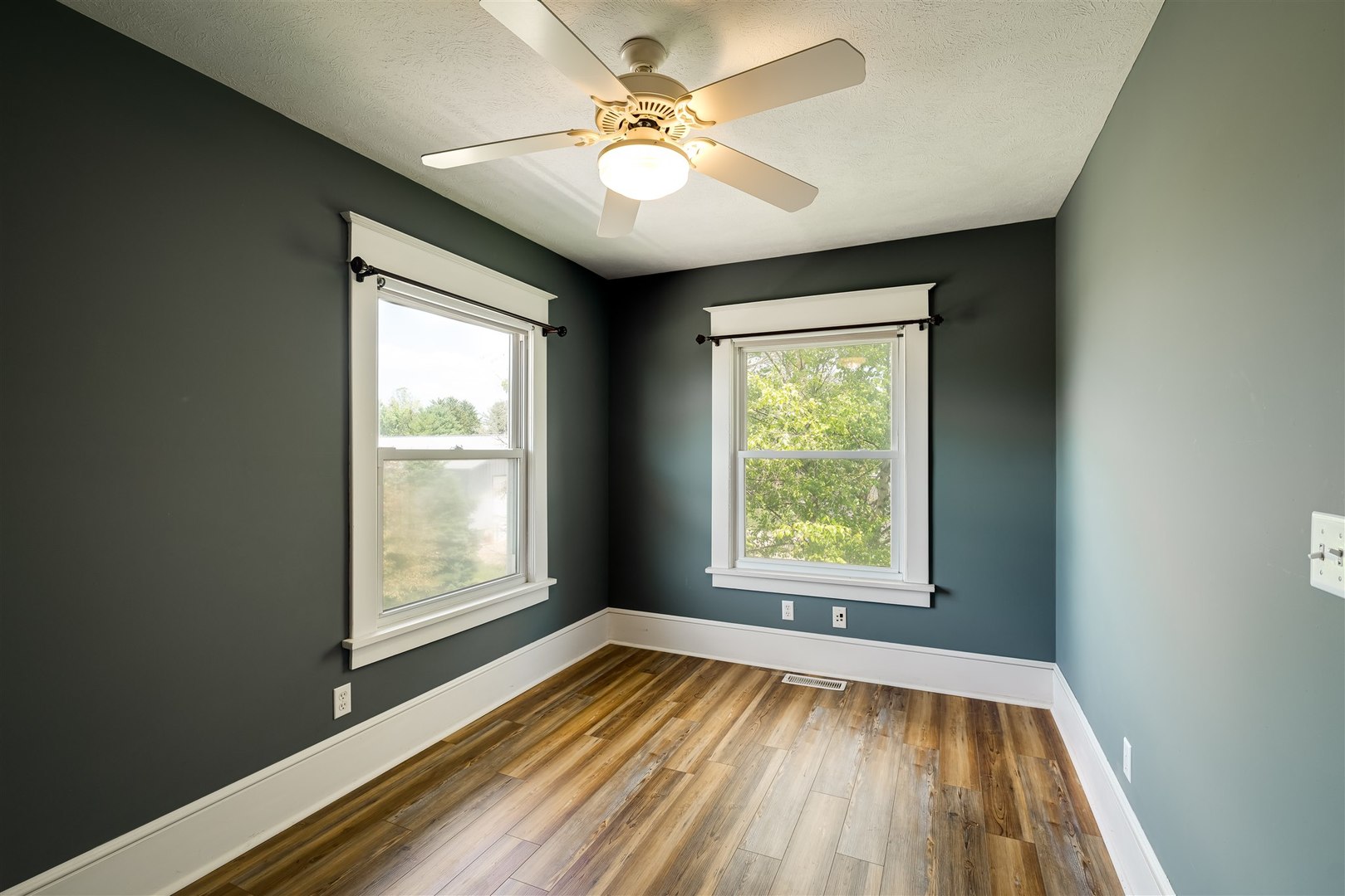 301 West Cooper Street Colfax, IL 61728 - Photo 22 of 69 a view of an empty room with a window and wooden floor
