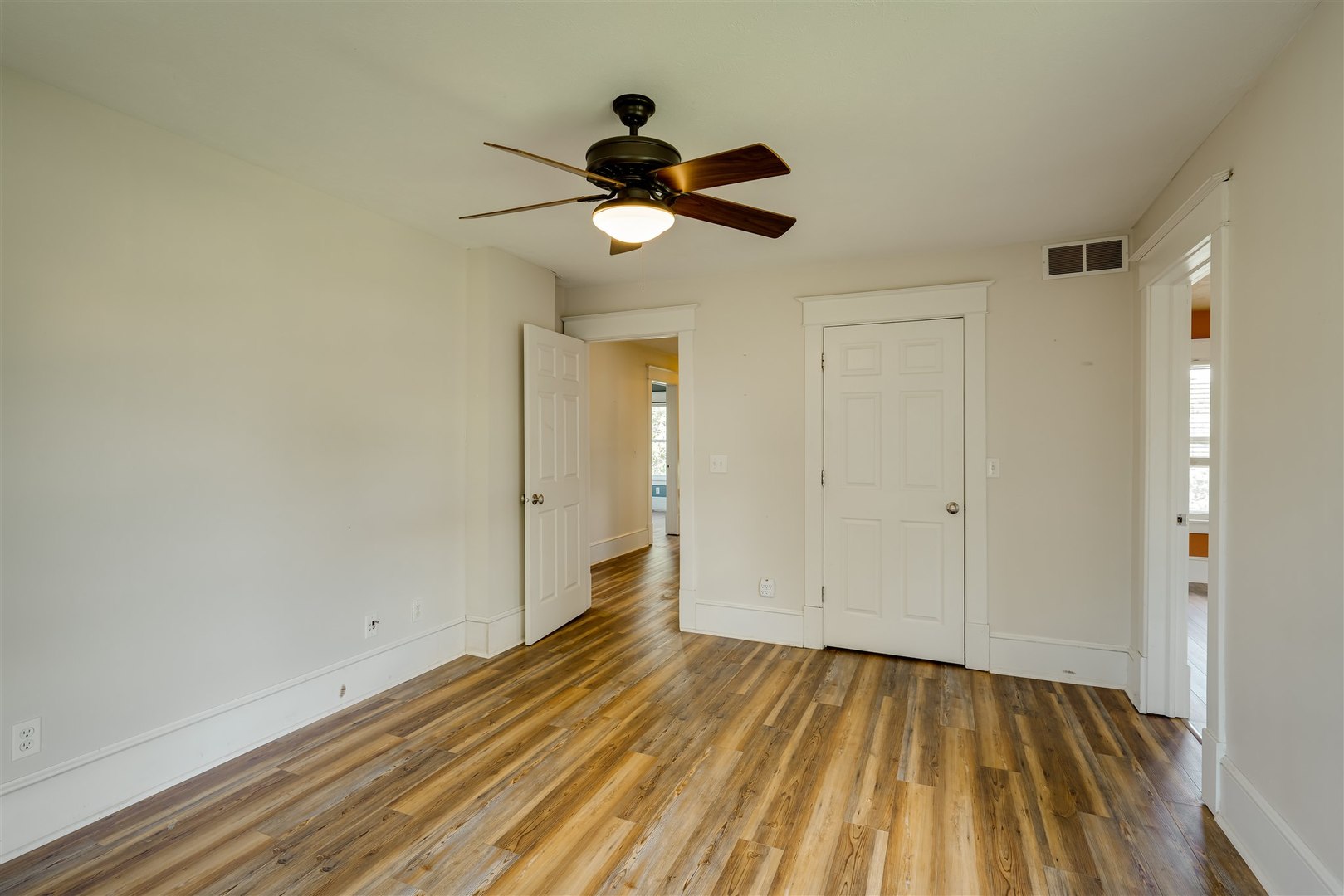 301 West Cooper Street Colfax, IL 61728 - Photo 26 of 69 a view of empty room with wooden floor and fan