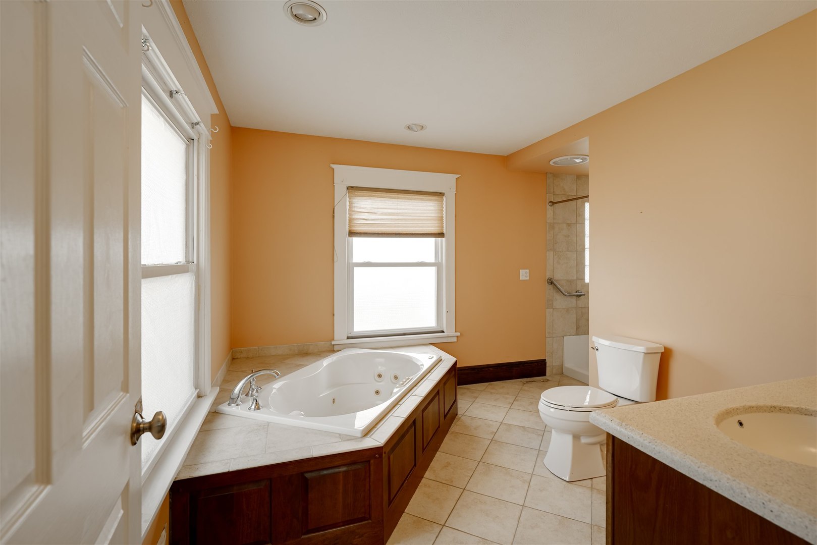 301 West Cooper Street Colfax, IL 61728 - Photo 27 of 69 a bathroom with a tub sink and mirror