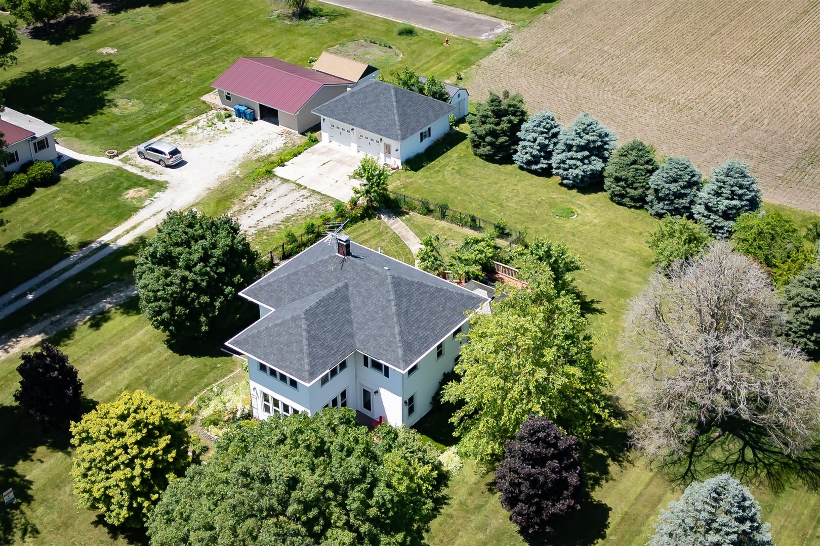 301 West Cooper Street Colfax, IL 61728 - Photo 57 of 69 an aerial view of a house with a yard and greenery