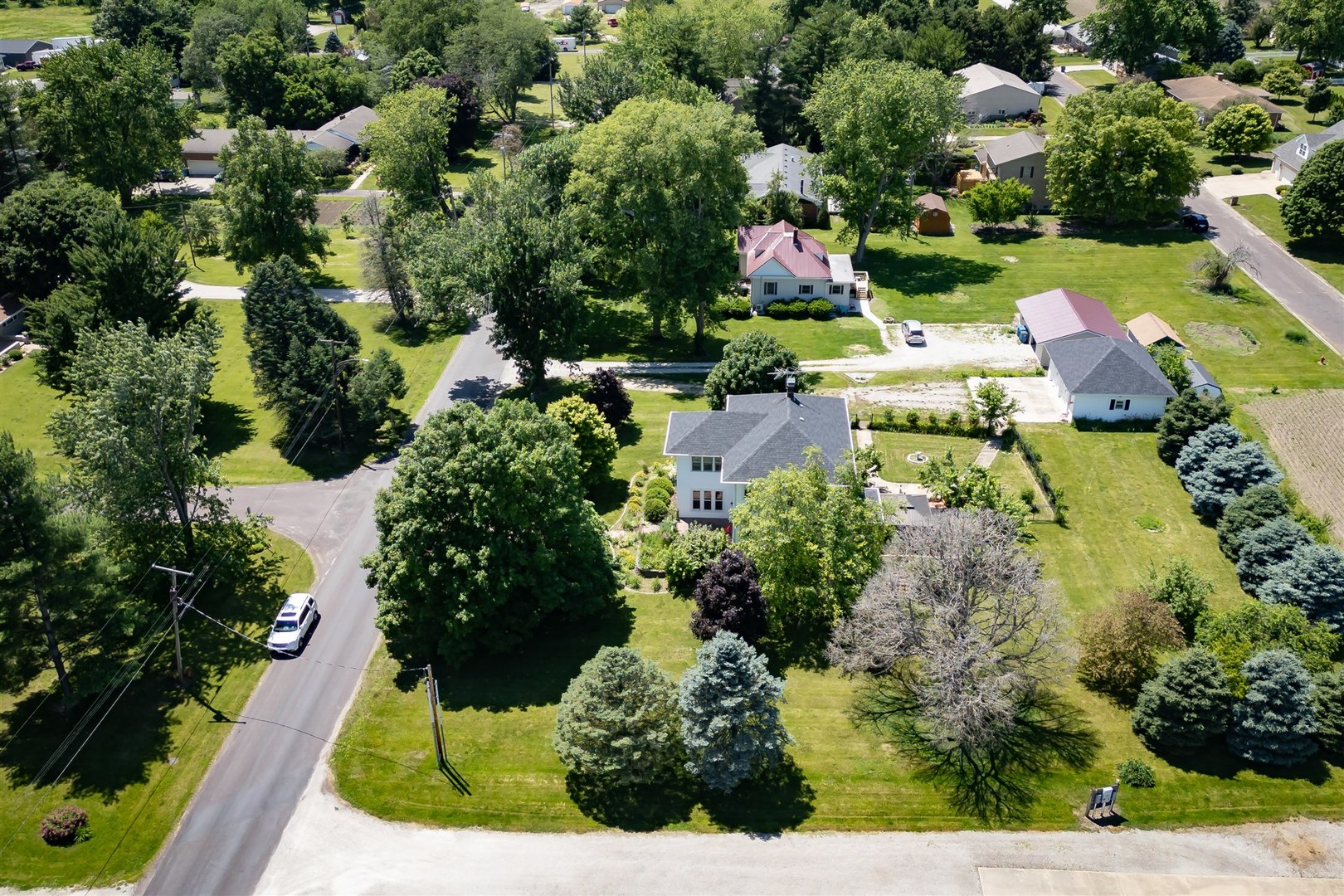 301 West Cooper Street Colfax, IL 61728 - Photo 59 of 69 an aerial view of a house with a garden and swimming pool