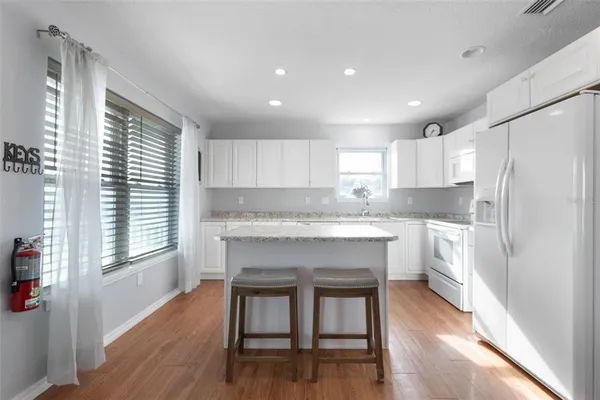 a kitchen with a refrigerator a sink and cabinets
