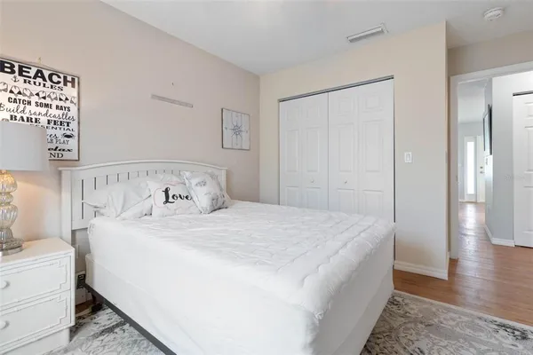 a bedroom with a large bed and a window