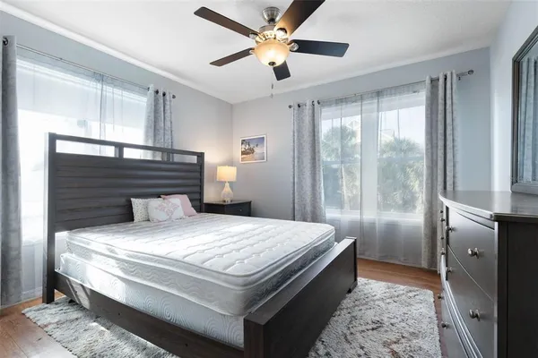 a bedroom with a bed and a lamp on table