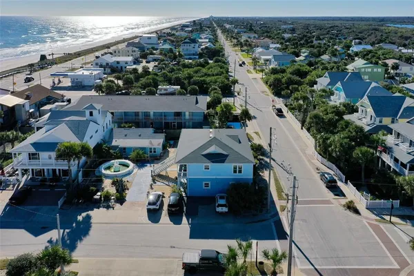an aerial view of a house with garden space and street view