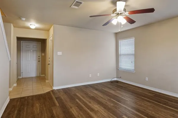 wooden floor in an empty room with a window