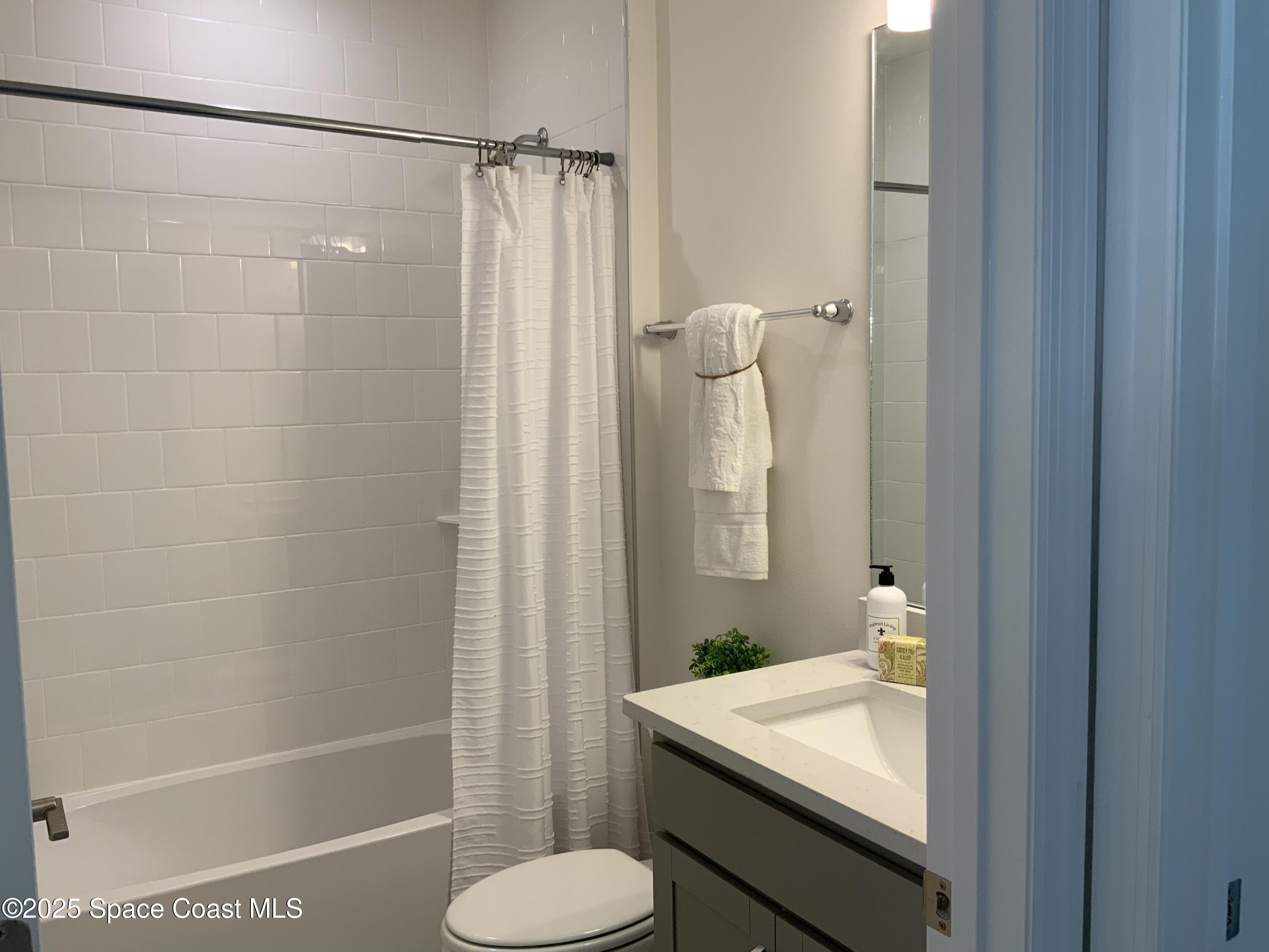 1787 Fallon Boulevard Northeast Palm Bay, FL 32907 - Photo 15 of 18 a bathroom with a sink toilet and shower