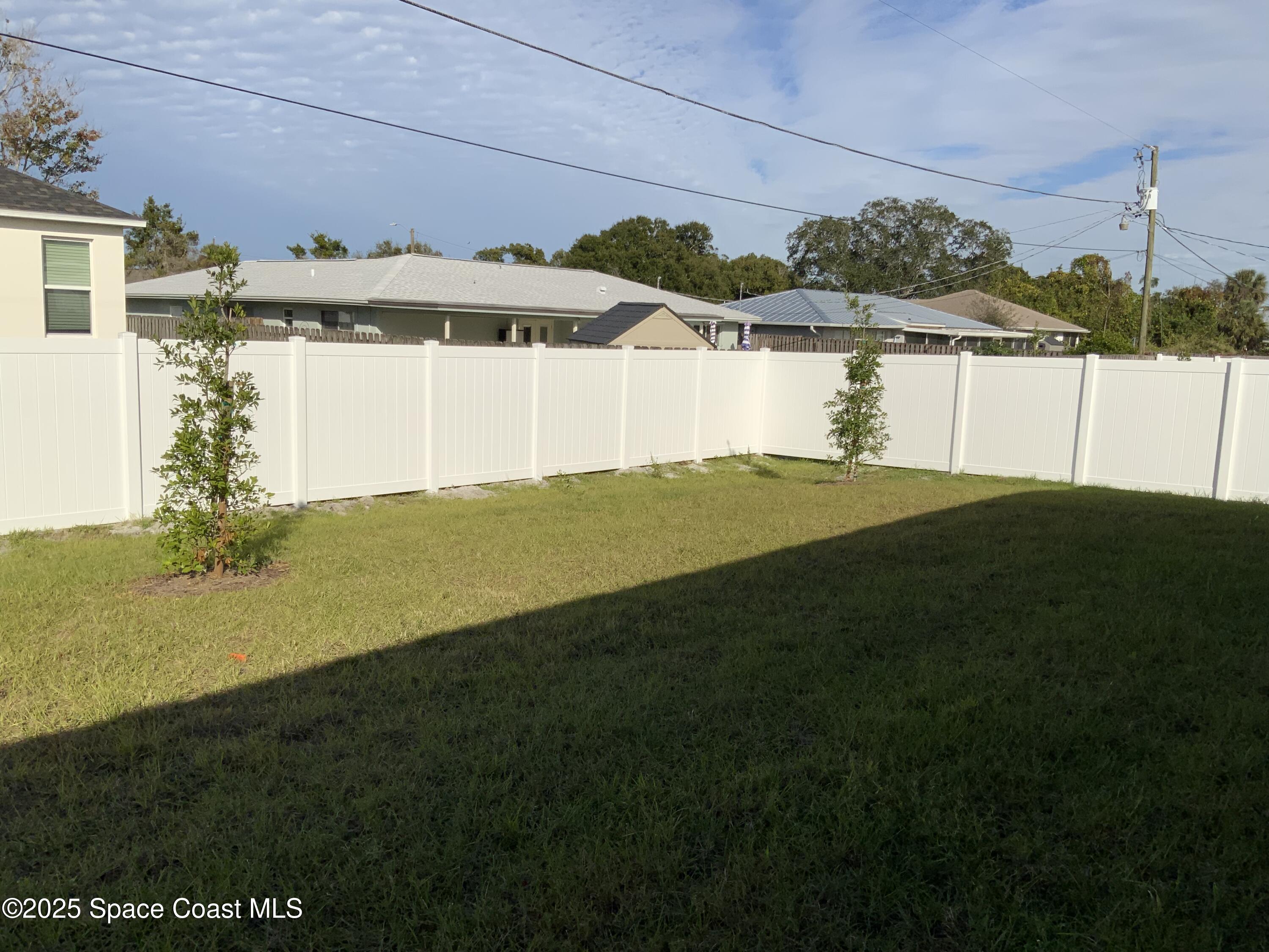 1787 Fallon Boulevard Northeast Palm Bay, FL 32907 - Photo 17 of 18 a view of a back yard of the house