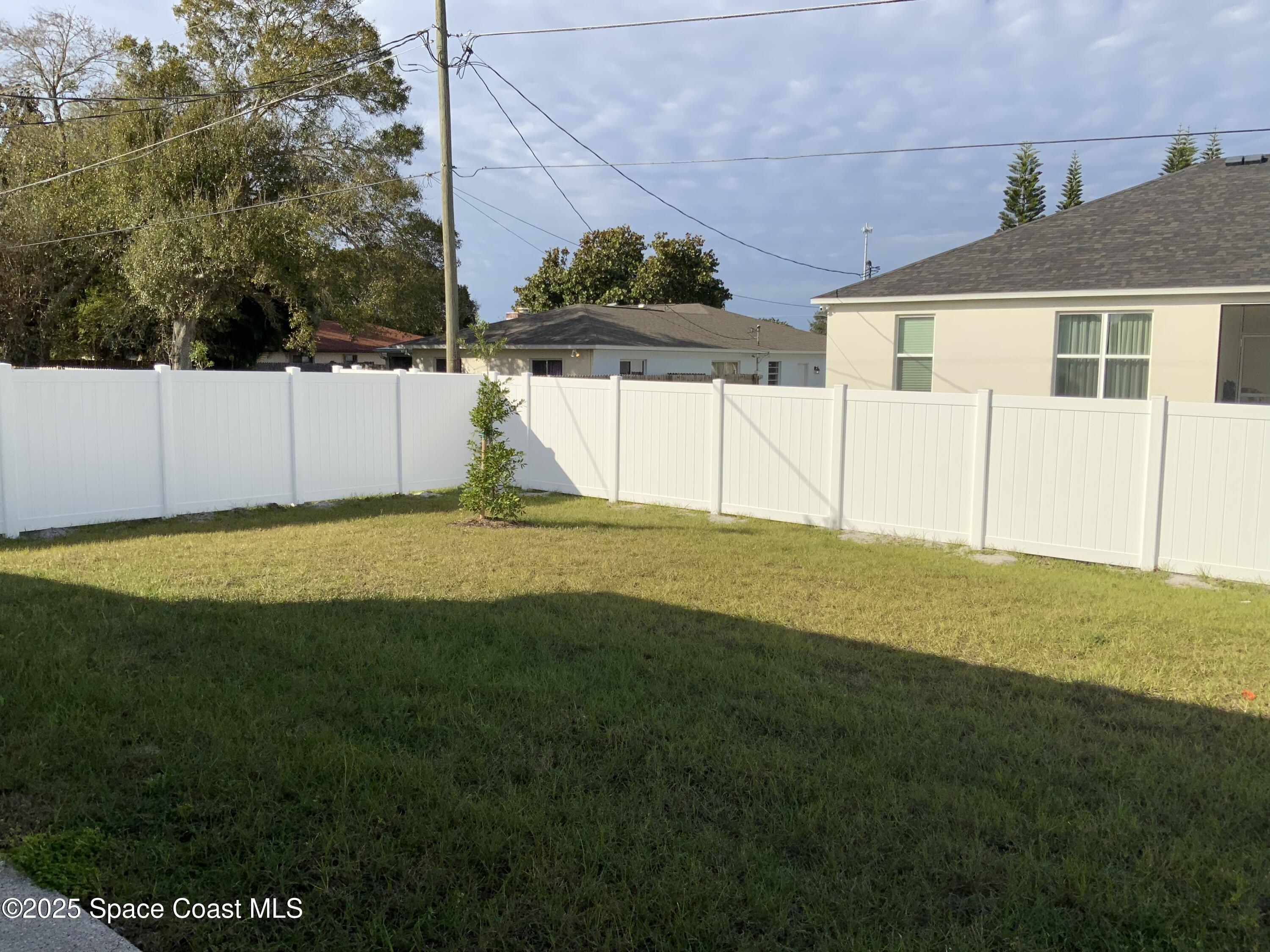 1787 Fallon Boulevard Northeast Palm Bay, FL 32907 - Photo 18 of 18 a view of a house with a backyard