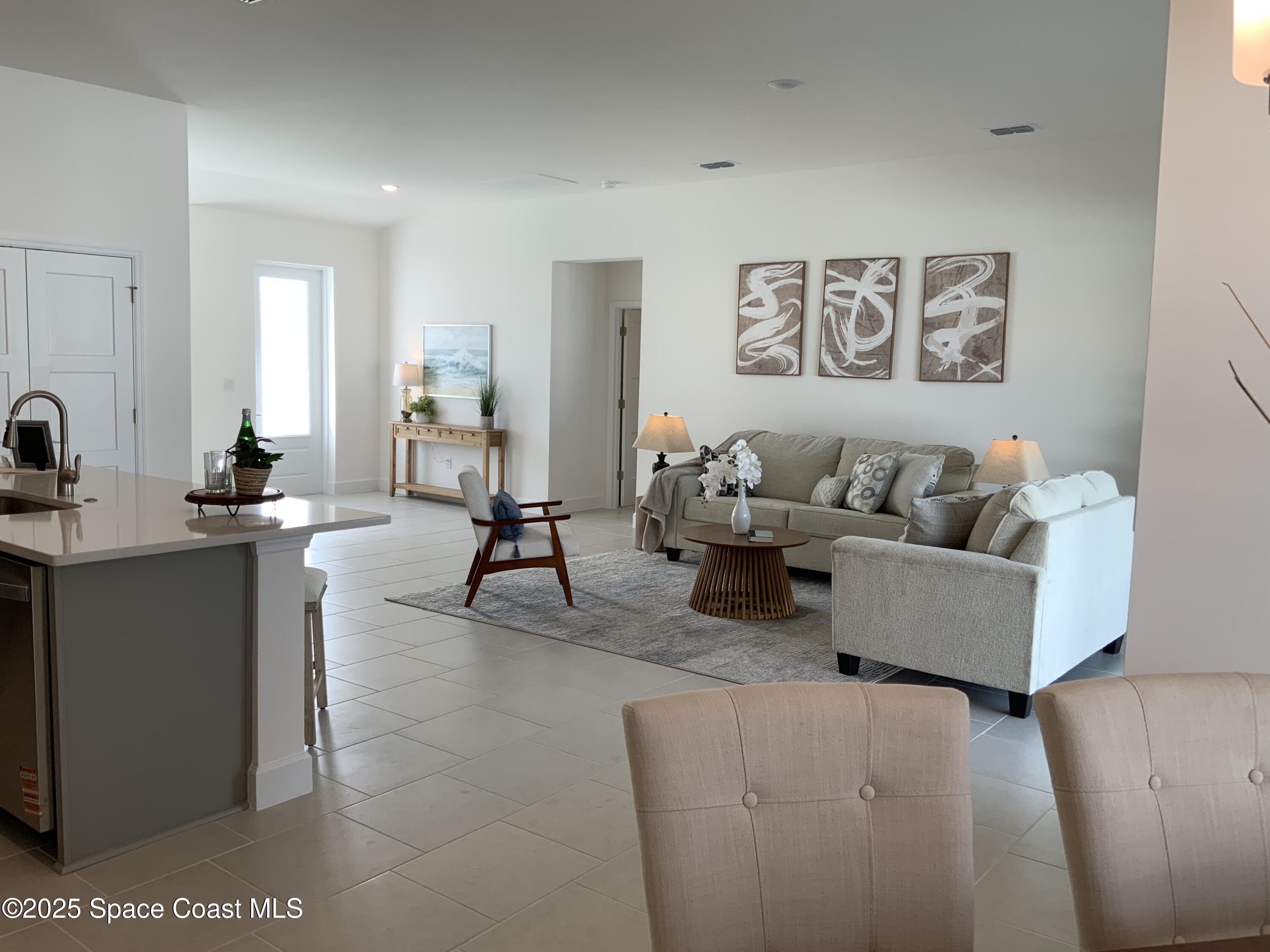 1787 Fallon Boulevard Northeast Palm Bay, FL 32907 - Photo 2 of 18 a living room with furniture and a table