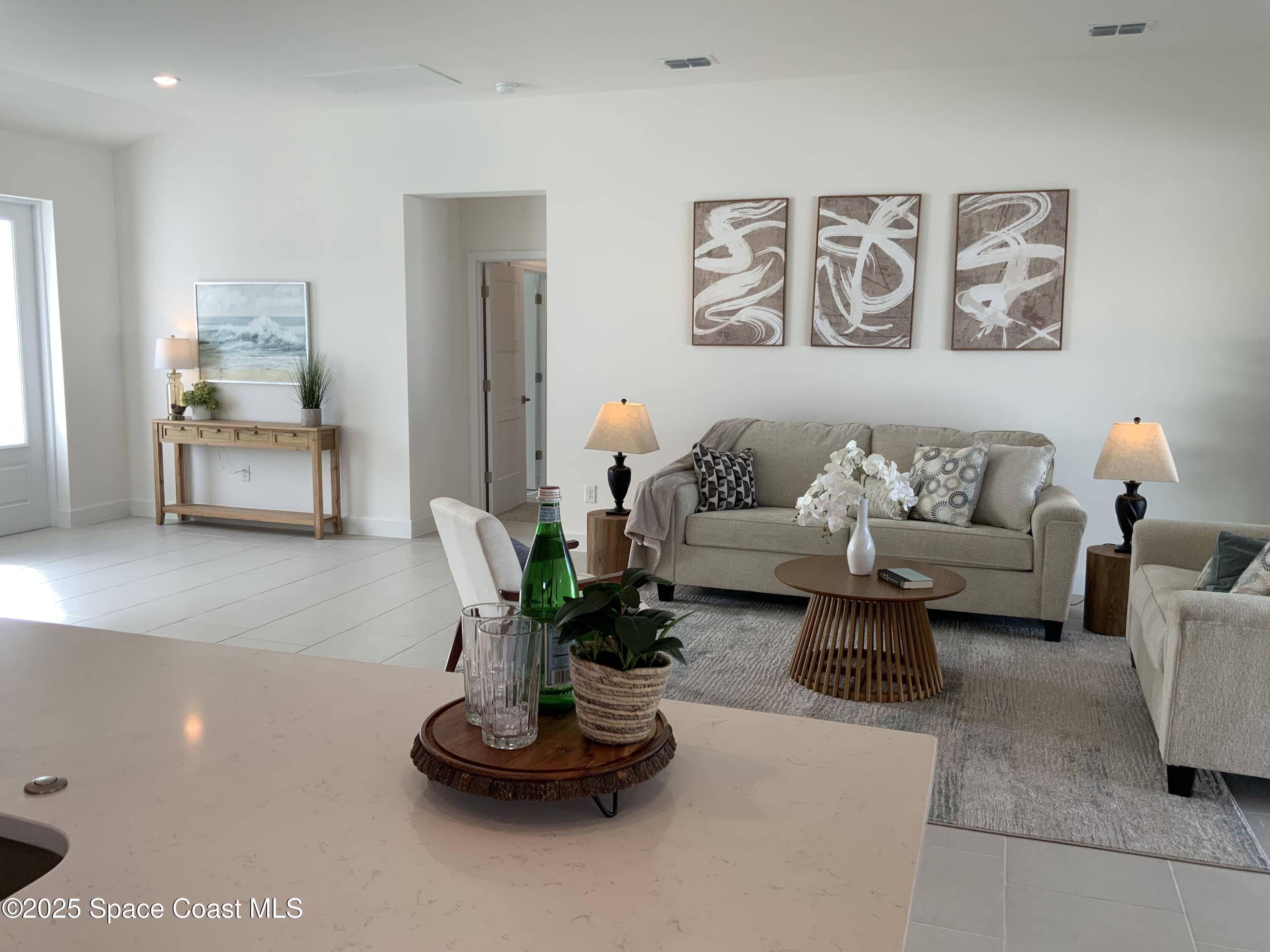 1787 Fallon Boulevard Northeast Palm Bay, FL 32907 - Photo 3 of 18 a living room with furniture flowerpot and a window