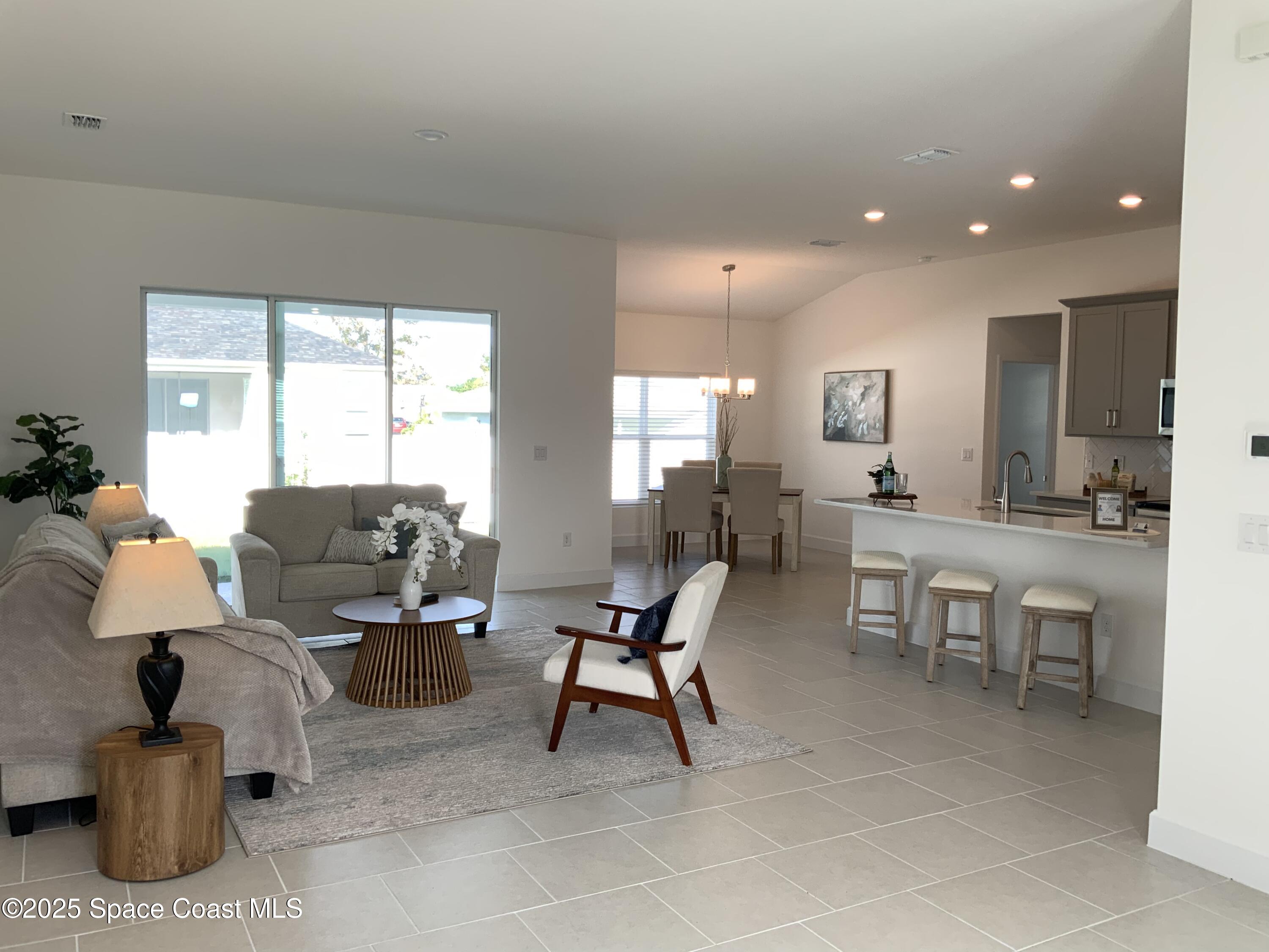 1787 Fallon Boulevard Northeast Palm Bay, FL 32907 - Photo 4 of 18 a living room with furniture and white walls