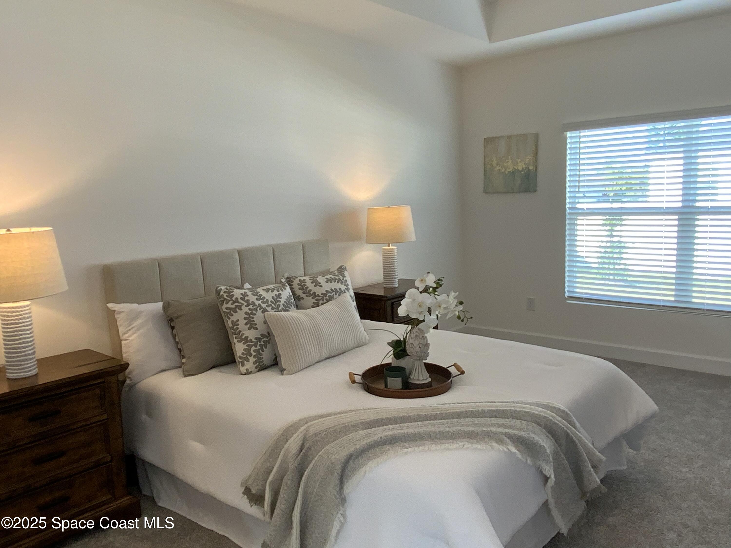 1787 Fallon Boulevard Northeast Palm Bay, FL 32907 - Photo 8 of 18 a bedroom with a bed and window