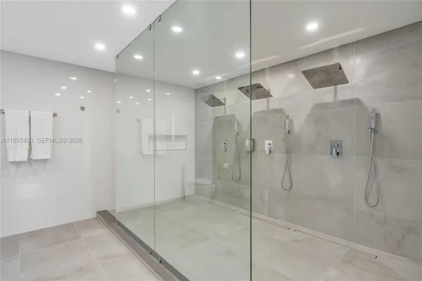 a bathroom with a shower and a glass door