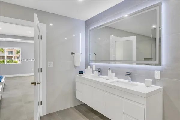 a bathroom with a double vanity sink mirror and