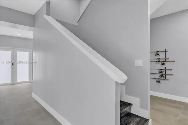 a view of hallway with stairs and wooden floor