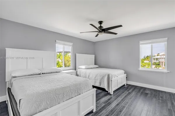 a bedroom with two beds and a window
