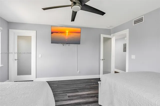 a bedroom with a bed and a flat screen tv