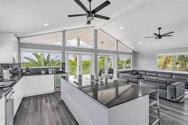 a kitchen with a counter top a sink and a large window