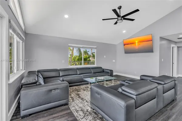 a living room with furniture and a flat screen tv