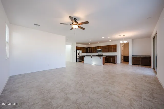 a view of a kitchen with a sink and a refrigerator