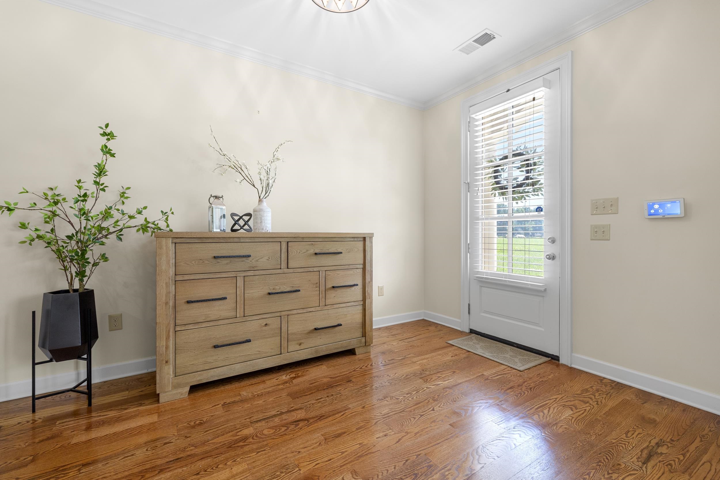 185 Belmont Road Mason, TN 38049 - Photo 7 of 38 Hardwood flooring throughout a room with light-colored walls and white trim