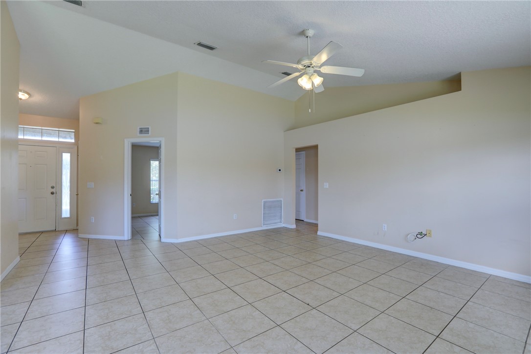 113 Drake Way Sebastian, FL 32958 - Photo 13 of 36 a view of an empty room and chandelier fan