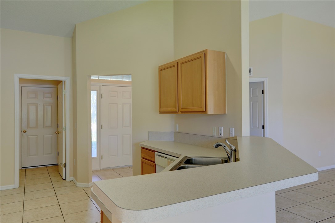 113 Drake Way Sebastian, FL 32958 - Photo 18 of 36 a room with a sink and cabinets