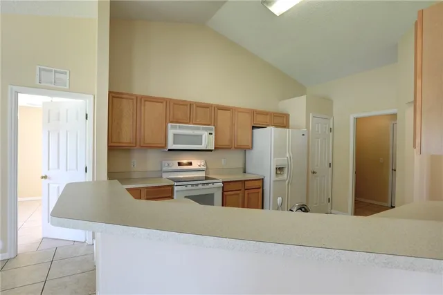a kitchen with stainless steel appliances a refrigerator and a stove