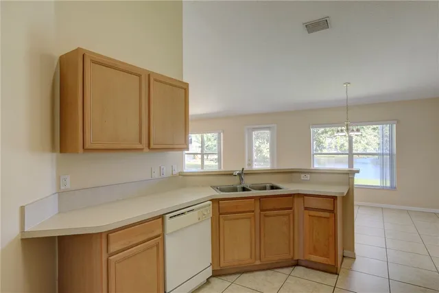 a kitchen with cabinets and window