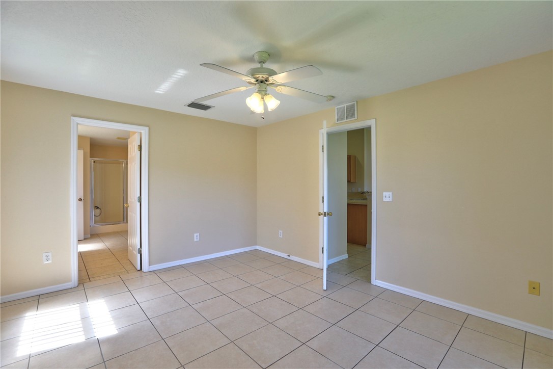 113 Drake Way Sebastian, FL 32958 - Photo 24 of 36 a view of an empty room and window chandelier fan