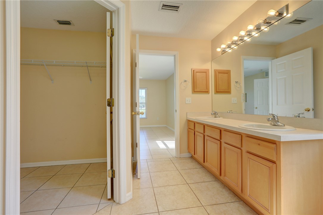 113 Drake Way Sebastian, FL 32958 - Photo 26 of 36 a bathroom with a double vanity sink and a mirror