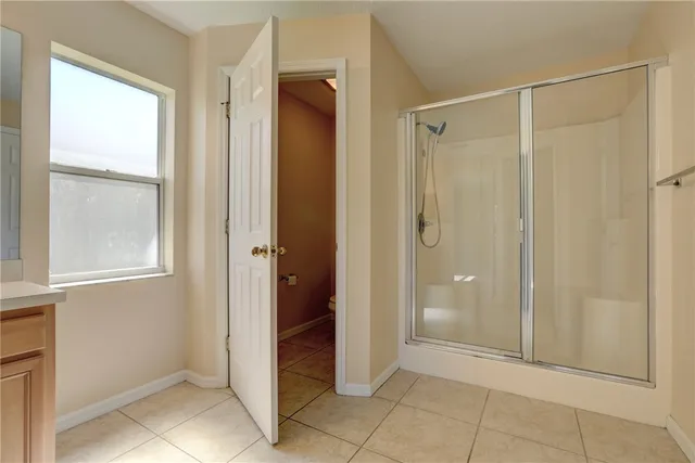 a bathroom with a shower and a sink